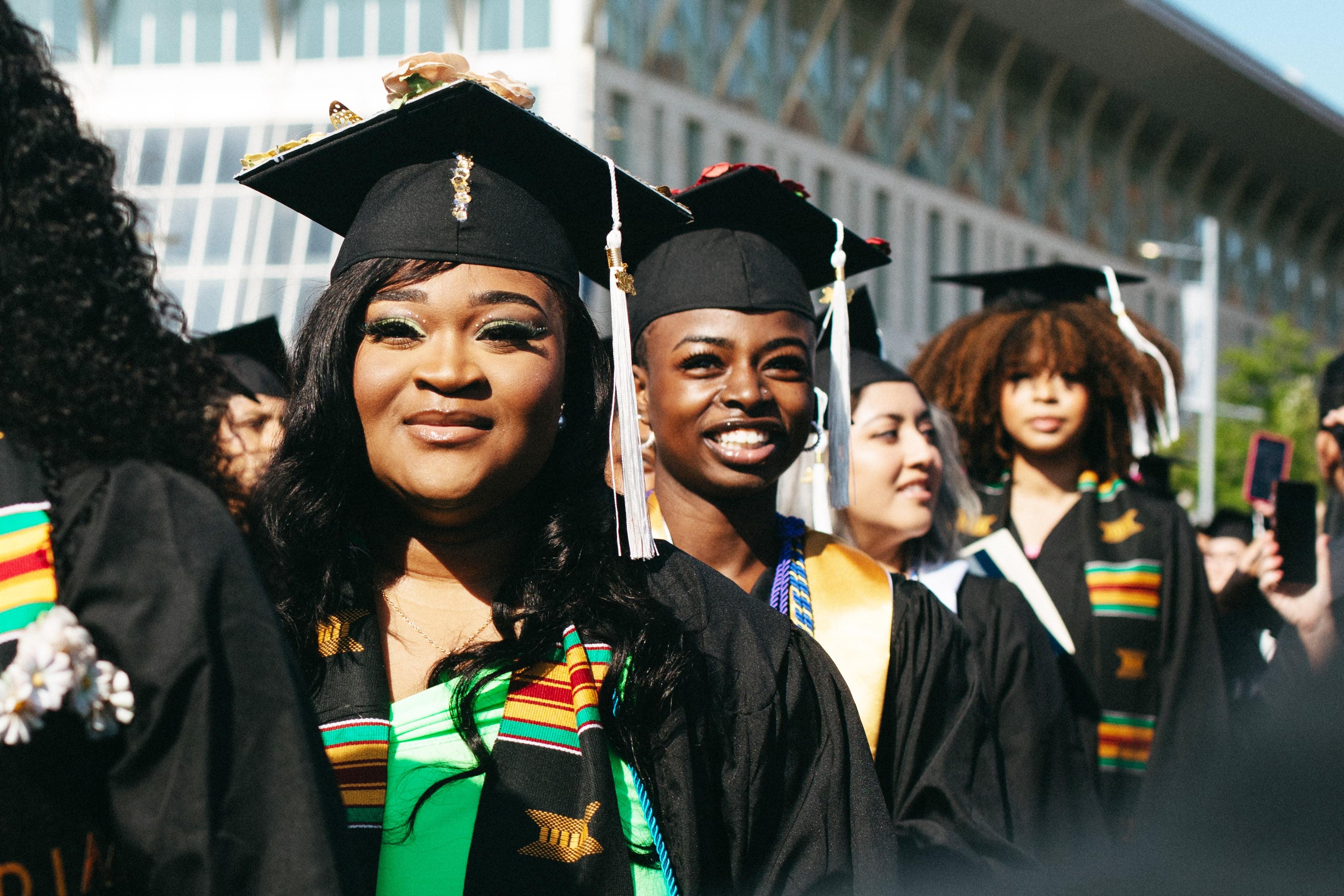 Four female students at UMass Boston's Commencement ceremony